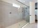Modern bathroom showcasing a spacious glass-enclosed shower and tile surround at 11560 Tapestry Ln, Venice, FL 34293