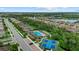 Community aerial view showcases swimming pool, tennis courts and bocce court surrounded by beautifully landscaped grounds at 11970 Lovegrass St, Venice, FL 34293