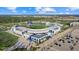 Daytime aerial view of a modern baseball stadium surrounded by lush greenery and a clear blue sky at 11970 Lovegrass St, Venice, FL 34293