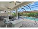Inviting screened-in patio area with a hot tub, pool, and outdoor kitchen at 11970 Lovegrass St, Venice, FL 34293