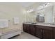 Bright bathroom featuring a double vanity, granite countertops, and a walk-in shower with glass door at 11970 Lovegrass St, Venice, FL 34293