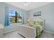 Comfortable bedroom with large window and coastal decor at 11970 Lovegrass St, Venice, FL 34293