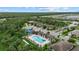 Aerial view of the community's recreational area featuring a pool, tennis courts, and nearby residential streets at 11970 Lovegrass St, Venice, FL 34293