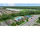 Aerial view of community pool, tennis court, bocce court and recreational facilities surrounded by lush greenery at 11970 Lovegrass St, Venice, FL 34293
