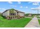 Beautiful single-Gathering home with lush landscaping, paver driveway, and a well-maintained lawn at 11970 Lovegrass St, Venice, FL 34293