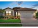Charming single-story home with a tile roof, landscaped yard, and attached garage at 11970 Lovegrass St, Venice, FL 34293