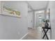 Inviting hallway with tile flooring, neutral paint, and decorative accents at 11970 Lovegrass St, Venice, FL 34293