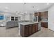 Open kitchen features a spacious island, stainless steel appliances, and seating at 11970 Lovegrass St, Venice, FL 34293
