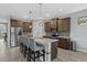 Open concept kitchen boasts a large island with seating and stainless steel appliances at 11970 Lovegrass St, Venice, FL 34293