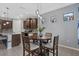 Eat-in kitchen featuring a wooden table, gray walls, and decorative window accents at 11970 Lovegrass St, Venice, FL 34293