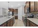 Modern kitchen features stainless steel appliances, granite countertops, and dark wood cabinetry at 11970 Lovegrass St, Venice, FL 34293