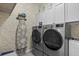 Laundry room featuring modern washer and dryer and lots of storage at 11970 Lovegrass St, Venice, FL 34293