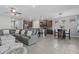 Open concept living space featuring kitchen, dining area, and gray leather couch at 11970 Lovegrass St, Venice, FL 34293
