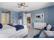 Tranquil main bedroom features a white bed, blue accents, and marble flooring at 11970 Lovegrass St, Venice, FL 34293