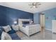 Serene main bedroom boasts a white bed, blue accents, and a soothing ambiance at 11970 Lovegrass St, Venice, FL 34293