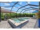 Screened in pool and spa with pavers and comfortable outdoor seating at 11970 Lovegrass St, Venice, FL 34293