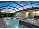 Screened in pool and spa with pavers and outdoor seating at 11970 Lovegrass St, Venice, FL 34293