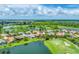 Aerial view of the community with lush landscaping and a golf course at 1210 Eagles Flight Way, North Port, FL 34287