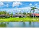 View of the backyard with a screened-in pool and lush landscaping at 1210 Eagles Flight Way, North Port, FL 34287