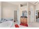 Bathroom featuring a walk-in shower, a separate tub, and wood cabinets at 1210 Eagles Flight Way, North Port, FL 34287