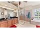 Bathroom featuring a walk-in shower, a separate tub, and wood cabinets at 1210 Eagles Flight Way, North Port, FL 34287