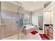 Bathroom featuring a walk-in shower, a separate tub, and a large window at 1210 Eagles Flight Way, North Port, FL 34287