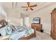 Bedroom with a decorative ceiling, a wood bed frame and matching wooden furniture at 1210 Eagles Flight Way, North Port, FL 34287
