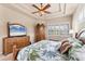 Bedroom with a decorative ceiling, a wood bed frame and matching wooden furniture at 1210 Eagles Flight Way, North Port, FL 34287