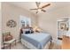 Comfortable bedroom features a ceiling fan and natural light through window with plantation shutters at 1210 Eagles Flight Way, North Port, FL 34287