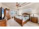 Bedroom with a decorative ceiling, a wood bed frame and matching wooden furniture at 1210 Eagles Flight Way, North Port, FL 34287