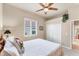 Bright bedroom with double closets, ceiling fan, and window with plantation shutters at 1210 Eagles Flight Way, North Port, FL 34287