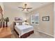 Comfortable bedroom features a ceiling fan and natural light through window with plantation shutters at 1210 Eagles Flight Way, North Port, FL 34287