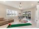 Bonus room features plantation shutters, golf putting, and outdoor access at 1210 Eagles Flight Way, North Port, FL 34287