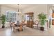 Cozy dining room featuring a wooden table, chandelier, and natural light from the large window at 1210 Eagles Flight Way, North Port, FL 34287