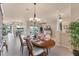 Open floor plan dining area with stylish furniture, a chandelier, and view of living areas at 1210 Eagles Flight Way, North Port, FL 34287