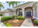Close-up of home's front entrance showcasing manicured landscaping and elegant architectural details at 1210 Eagles Flight Way, North Port, FL 34287