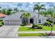 Charming single-story residence featuring a three-car garage and a beautifully landscaped front yard at 1210 Eagles Flight Way, North Port, FL 34287