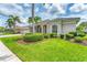 Beautiful single-story home with lush landscaping, a three-car garage, and a welcoming front entrance at 1210 Eagles Flight Way, North Port, FL 34287
