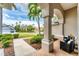 Inviting front porch with brick flooring and beautifully landscaped front yard and view of neighborhood at 1210 Eagles Flight Way, North Port, FL 34287