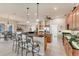 Open kitchen features an island with bar seating and modern appliances at 1210 Eagles Flight Way, North Port, FL 34287