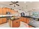 Spacious kitchen with wood cabinetry, center island, and views into the living area at 1210 Eagles Flight Way, North Port, FL 34287