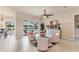 Bright living room with neutral tones, tile flooring, and a view of the outdoor pool and patio at 1210 Eagles Flight Way, North Port, FL 34287
