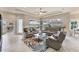 Open living room with modern furnishings and access to patio at 1210 Eagles Flight Way, North Port, FL 34287