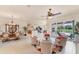 Spacious open concept living room with a dining area, kitchen, and access to the outdoor patio at 1210 Eagles Flight Way, North Port, FL 34287