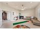 Spacious living room featuring a sectional sofa, ceiling fan, and tile flooring at 1210 Eagles Flight Way, North Port, FL 34287