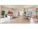 Spacious living room featuring a dining area, ample natural light, and neutral decor at 1210 Eagles Flight Way, North Port, FL 34287