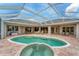 Backyard screened-in pool and patio area with access to the home's interior at 1210 Eagles Flight Way, North Port, FL 34287
