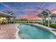 Inviting screened-in pool and spa with a spacious patio and views of the golf course at 1210 Eagles Flight Way, North Port, FL 34287
