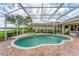 A private screened-in pool with a fountain provides the perfect outdoor oasis at 1210 Eagles Flight Way, North Port, FL 34287