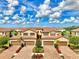 Beautiful, sunny aerial view of townhomes with brick driveways and manicured landscaping at 12590 Ghiberti Cir # 201, Venice, FL 34293